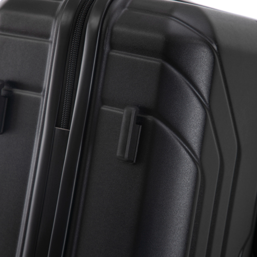 Close-up of a black suitcase handle and side panel