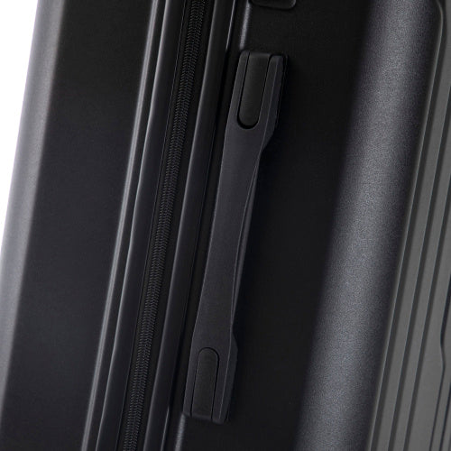 Close-up of a black suitcase handle on a white background